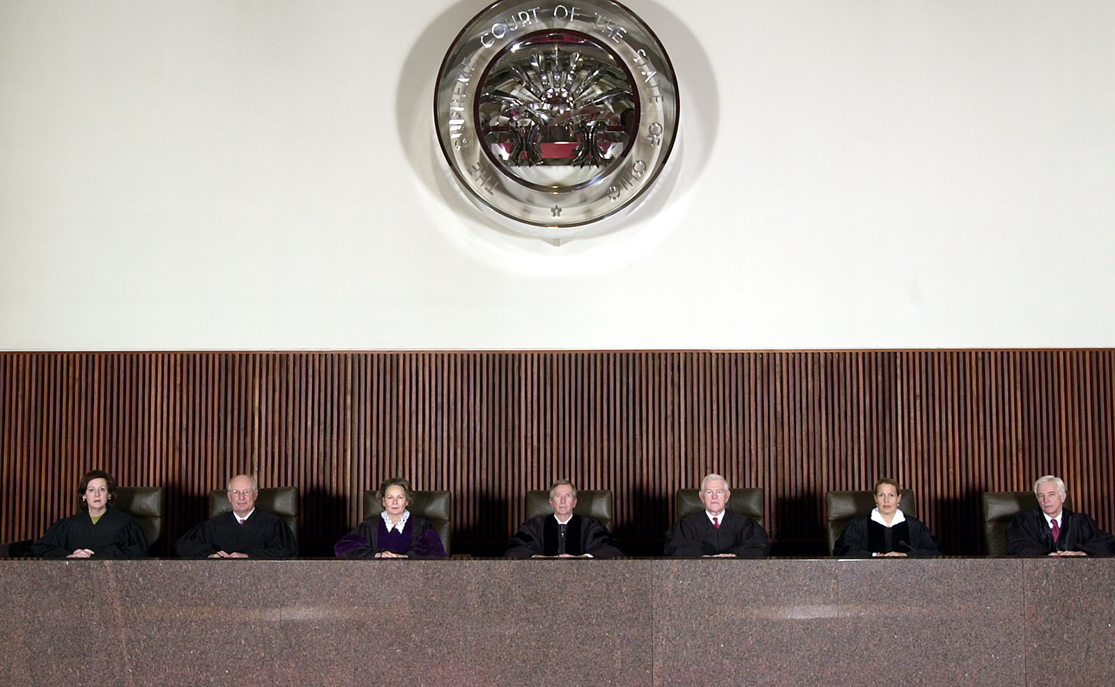 Image of the seven Ohio Supreme Court Justices sitting on the bench in the courtroom when the Court was located in the Rhodes State Office Tower